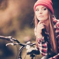 Girl relaxing in autumnal park with bicycle. Royalty Free Stock Photo