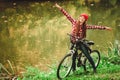 Girl relaxing in autumnal park with bicycle. Royalty Free Stock Photo