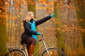 Girl relaxing in autumnal park with bicycle Royalty Free Stock Photo