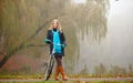 Girl relaxing in autumnal park with bicycle Royalty Free Stock Photo