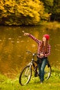 Girl relaxing in autumnal park with bicycle Royalty Free Stock Photo