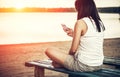 Girl relaxing on the beach with phone Royalty Free Stock Photo