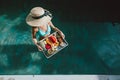 Girl relaxing and eating fruits in the pool on luxury villa in Bali Royalty Free Stock Photo