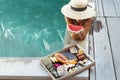 Girl relaxing and eating fruits in the pool on luxury villa in Bali Royalty Free Stock Photo