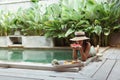 Girl relaxing and eating fruits in the pool on luxury villa in Bali Royalty Free Stock Photo