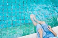 The girl relaxing feet with water in the pool Royalty Free Stock Photo