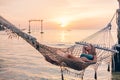 Girl relaxing in hammock on sunset beach Royalty Free Stock Photo