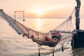 Girl relaxing in hammock on sunset beach Royalty Free Stock Photo