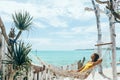 Girl relaxing in hammock in tropical beach cafe Royalty Free Stock Photo