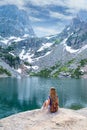 Girl relaxing by the lake in the mountains. Royalty Free Stock Photo