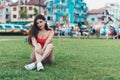 Girl relaxing on the lawn in a city park