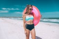 Girl relaxing on pink lilo on the beach Royalty Free Stock Photo