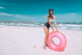 Girl relaxing on pink lilo on the beach Royalty Free Stock Photo