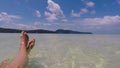 The girl is relaxing in the sea. Beautiful view of the sea and legs.