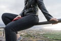 Girl relaxing sitting in fence on a viewpoint and cell phone in her legs. Curvy Teen sit in hilltop in silence and serenity