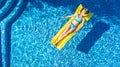 Girl relaxing in swimming pool, child swims on inflatable mattress and has fun in water on family vacation, tropical holiday