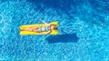 Girl relaxing in swimming pool, child swims on inflatable mattress and has fun in water on family vacation, tropical holiday
