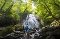 Man enjoying beautiful waterfall. Royalty Free Stock Photo