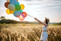 Girl releases a bunch of balloons into the sky