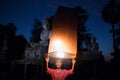 The girl is releasing the lamp. Thailand culture in rural