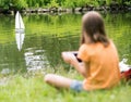 Girl with remote controlled boat Royalty Free Stock Photo