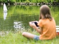 Girl with remote controlled boat Royalty Free Stock Photo