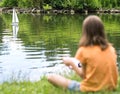 Girl with remote controlled boat Royalty Free Stock Photo