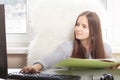 The girl at a remote work at home, prints on a computer, parses folders with documents Royalty Free Stock Photo