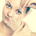 Girl removing facial peel off mask Royalty Free Stock Photo