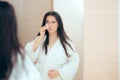 Woman in Bathrobe Cleaning Her Face with Make-up Remover Royalty Free Stock Photo