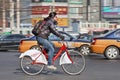 Girl on a rental bike in busy traffic, Beijing, China