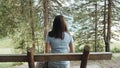 Girl Resting on a Bench By The Lake With a View of The Mountains And Forest. Girl Admires The Lake And Mountains Royalty Free Stock Photo