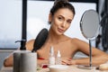 Girl resting her elbows on a dresser Royalty Free Stock Photo