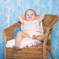 Girl resting in rattan chair