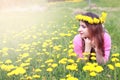 Girl resting on a sunny day in meadow of yellow dandelions Royalty Free Stock Photo