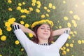 Girl resting on a sunny day in meadow of yellow dandelions Royalty Free Stock Photo