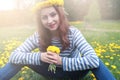 Girl resting on a sunny day in meadow of yellow dandelions Royalty Free Stock Photo