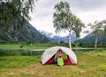 The girl is resting in a tent in the mountains of Norway Royalty Free Stock Photo