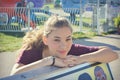 Girl Rests Head on Bench