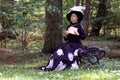 Girl in retro dress past century read letter on bench