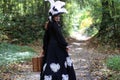 Girl in retro dress 18th century with valise in park Royalty Free Stock Photo