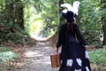 Girl in retro dress 18th century with valise in park Royalty Free Stock Photo