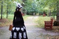 Girl in retro dress 18th century with valise in park Royalty Free Stock Photo