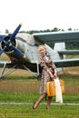 Girl in retro style with yellow suitcase