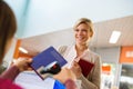 Girl returning book to librarian in library