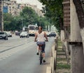 Girl ridding a bicycle on the streets of Bucharest