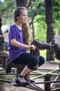 A girl ridding on a wooden horse