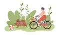 A girl rides a bicycle and a cheerful dog runs next to her. Royalty Free Stock Photo