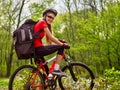 Girl rides bicycle on green grass in park outdoor. Royalty Free Stock Photo