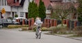 Girl Rides Bike Among Private Houses In Europe